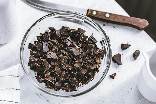 Sugar-free Schoolyard Snacks chocolates cut into pieces in a bowl with knife placed beside.